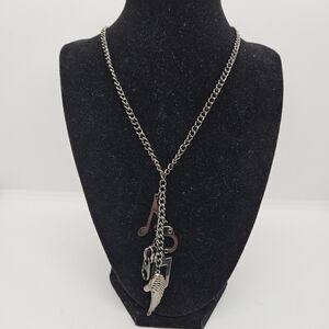 Claires gunmetal chain necklace with music notes handcuff zipper angel wing